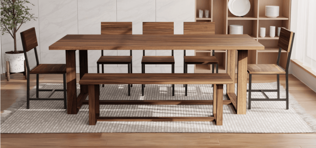 A wooden dining table set with four chairs and a walnut bench on a textured rug exudes timeless elegance. Shelves in the background showcase white dishes. A potted plant graces the corner, while sunlight streams through a window, enhancing the space's functionality.